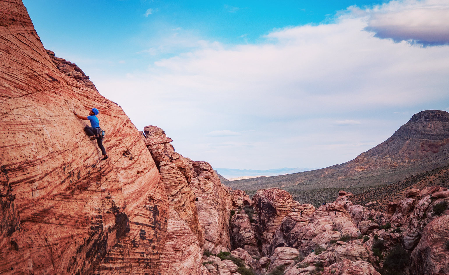 Person Climbing on Brown Mountain